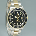 MINT 2000 Rolex GMT-Master 16713 Black Two-Tone Yellow Gold and Steel Oyster Watch